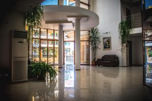 a lobby with potted plants in a building at Apart Hotel Apolonia Palace in Sinemorets