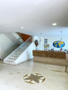 a room with a staircase and a rug on the floor at Hotel Continental Plaza in Barranquilla