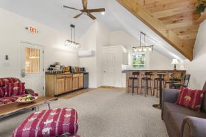 a living room with a couch and a kitchen at Blue Spruce Inn & Suites in Valatie