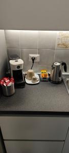 a kitchen counter top with a coffee maker and appliances at Casa Ricci in Acilia