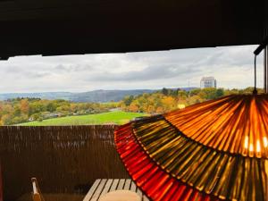 a close up of an umbrella on a balcony at Klassen Stay - Design Studio in 11 Etage - Tolle Aussicht - Sauna - Netflix in Lahnstein
