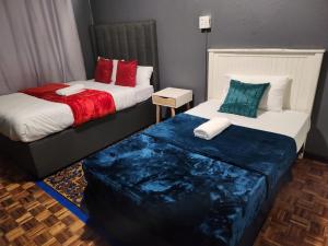 two beds sitting next to each other in a room at Ezcel accommodation in Cape Town