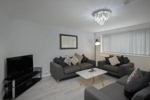 a living room with a couch and a tv at Lovely Home in Blackpool For You in Blackpool