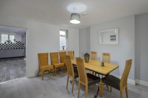 a dining room with a wooden table and chairs at Lovely Home in Blackpool For You in Blackpool