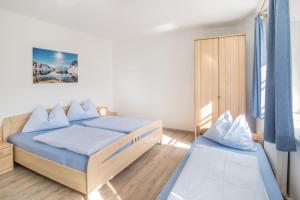 a bedroom with two beds and a closet at Rieplhof in Vipiteno