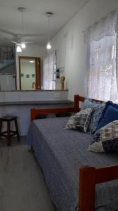 a bedroom with a bed and a large mirror at Chalés Manacá da Serra in Ubatuba