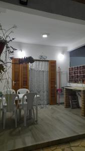 a dining room with a table and chairs at Chalés Manacá da Serra in Ubatuba