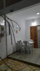 a group of tables and chairs in a room at Chalés Manacá da Serra in Ubatuba