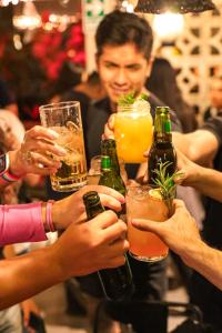 a group of people holding drinks on a bar at Black Llama Hostel Miraflores in Lima