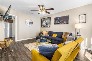 a living room with a couch and a ceiling fan at Home away from home! Min from the airport and downtown in Atlanta