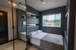 a bedroom with a bed and a window at Nilmare Apart Hotel in Itapema +77 photos