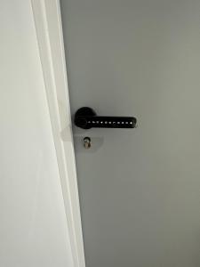a door with a black door knob on a white door at Résidence République in Dijon +3 photos