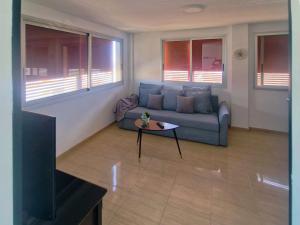 a living room with a couch and a table at Live Poris La Morra in Poris de Abona