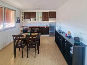 a kitchen with a table and chairs in a kitchen at Live Poris La Morra in Poris de Abona