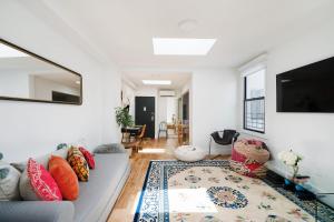 a living room with a couch and a tv at 3 BR 1 Bath Prime Williamsburg in Brooklyn