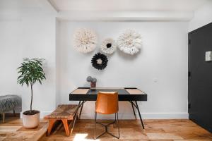 a dining room with a table and two wreaths on the wall at 3 BR 1 Bath Prime Williamsburg in Brooklyn