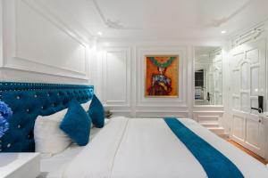 a bedroom with a large bed with a blue headboard at Diamond Hotel Sapa in Sa Pa