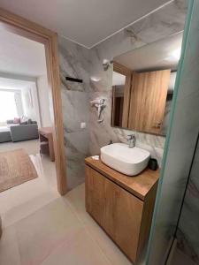 a bathroom with a sink and a shower at Minimal Cozy Apartment in Mytilini