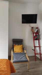 a room with a bed and a tv on a wall at La casetta di Cecilia in Trani