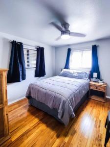a bedroom with a bed and a ceiling fan at Aurora House in Aurora