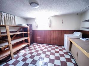 a kitchen with a checkered floor and a room with a counter at Aurora House in Aurora