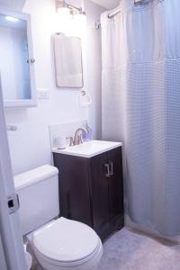 a bathroom with a toilet and a sink and a shower at Aurora House in Aurora