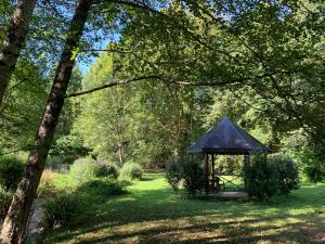 a gazebo in the middle of a park at Chalet Tulasi, douceur et sérénité à Eysus in Eysus