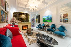 a living room with a red couch and a fireplace at Diamond Hotel Sapa in Sapa