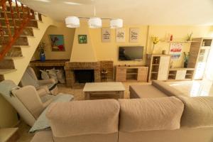 a living room with a couch and a fireplace at Casa rural El Tejar de Algar / 1262 in Algar