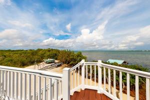 a balcony with a view of the water at Amada Grenada in Summerland Key