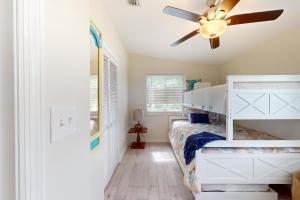 a bedroom with a bunk bed and a ceiling fan at Amada Grenada in Summerland Key