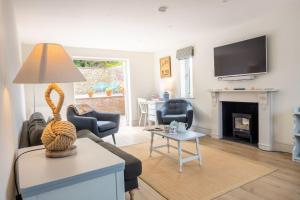 a living room with a couch and a fireplace at Neptune House in Wells next the Sea