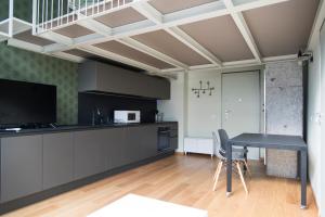 a kitchen with a table and a dining room at Youhosty - Lambro12 in Milan