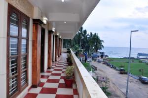 a building with a red and white checkered floor at The Banyan Tree Samudra in Kovalam