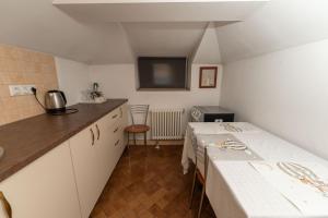 a small kitchen with a table and a counter top at George&Dragon Rooms in Bucharest