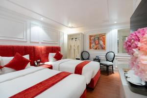 a hotel room with two beds and a desk at Diamond Hotel Sapa in Sapa +109 photos