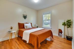 a bedroom with a bed with an orange blanket at Charming Boho Home Near OSU, Short North, Downtown in Columbus