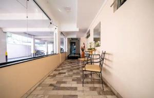 a hallway with a table and chairs in a building at Residencial Primavera in Balneário Camboriú