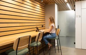 a woman sitting at a desk with a laptop at RK Farallón Canteras in Las Palmas de Gran Canaria