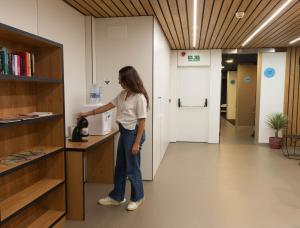 a woman standing at a counter in a room at RK Farallón Canteras in Las Palmas de Gran Canaria