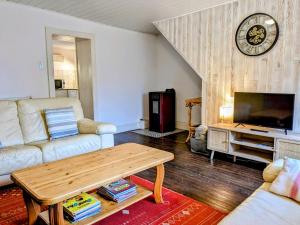 a living room with a couch and a coffee table at Gîtes Le Verger in Taintrux