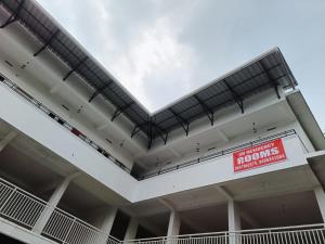 a large white building with a sign on it at SN Residency in Kalpetta