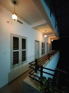 a hallway with benches in a building at night at SN Residency in Kalpetta