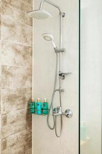 a shower with a shower head in a bathroom at Santa Triada in Heraklio