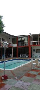 um hotel com piscina e cadeiras e um edifício em Villa del sol em San Rafael