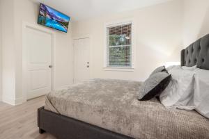 a bedroom with a large bed and a window at Brand New Stylish Home for Your Family in Tallahassee