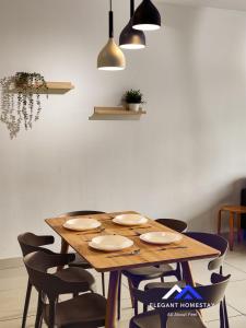 a wooden table with chairs and a dining room at 1 Tebrau By Elegant Johor Bahru in Johor Bahru