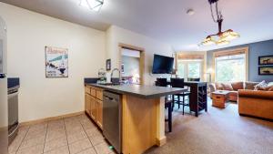 a kitchen and living room with a couch and a table at Sunstone #206 Condo in Mammoth Lakes