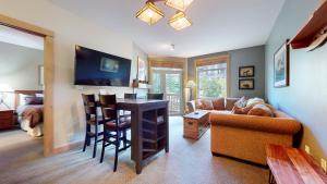 a living room with a couch and a table with a desk at Sunstone #206 Condo in Mammoth Lakes