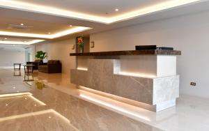 a lobby with a reception counter in a building at Canyon Hotels & Resorts Boracay in Boracay